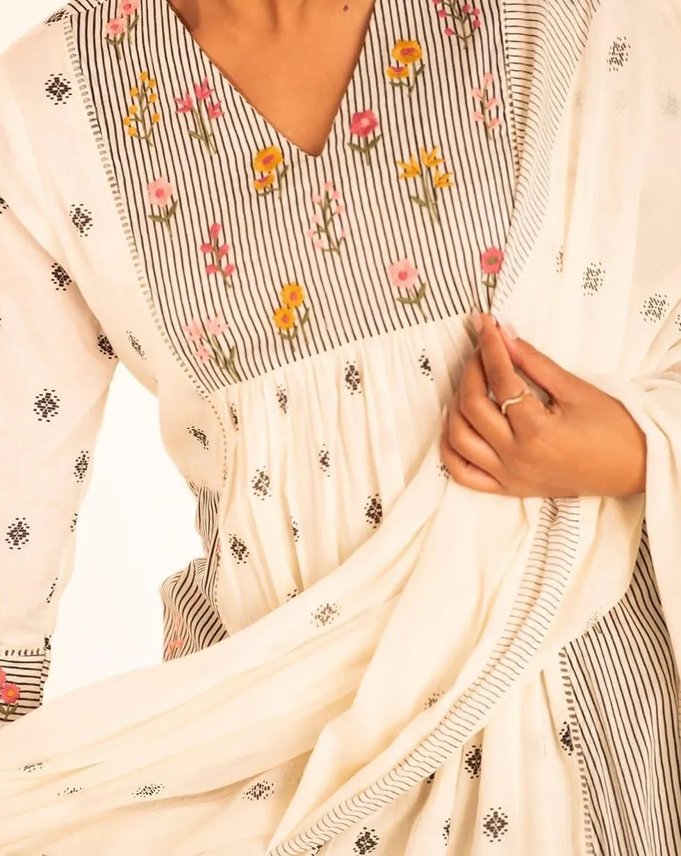Ivory cotton suit set with black motif print and floral striped panels — Floral and striped detail