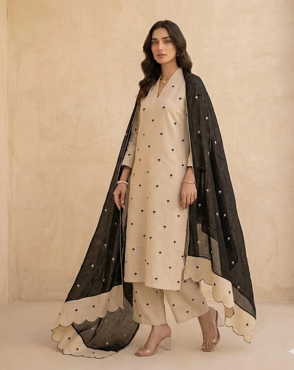 Ivory cotton kurta and trousers with small black motifs and a black dupatta with scalloped ivory border - view 1
