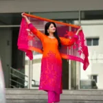 Orange and fuchsia Mul Silk suit set with floral detailing, fuchsia trousers and coordinating sheer dupatta